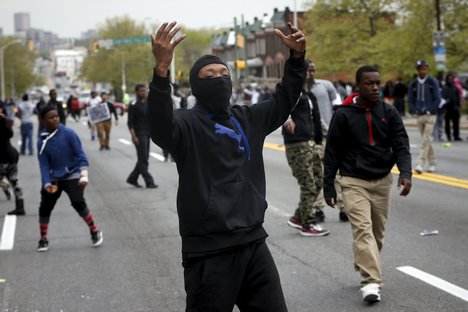 Demonstrators yell at Baltimore police during clashes in Baltimore, Maryland